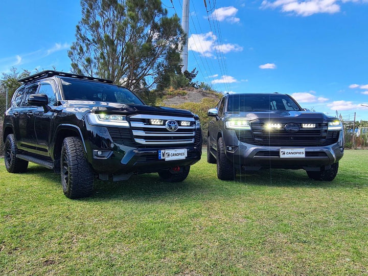 Two Toyota Land Cruisers with grille lights
