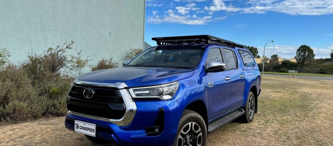 rhino roof rack with backbone mounting system installed on blue Toyota Hilux